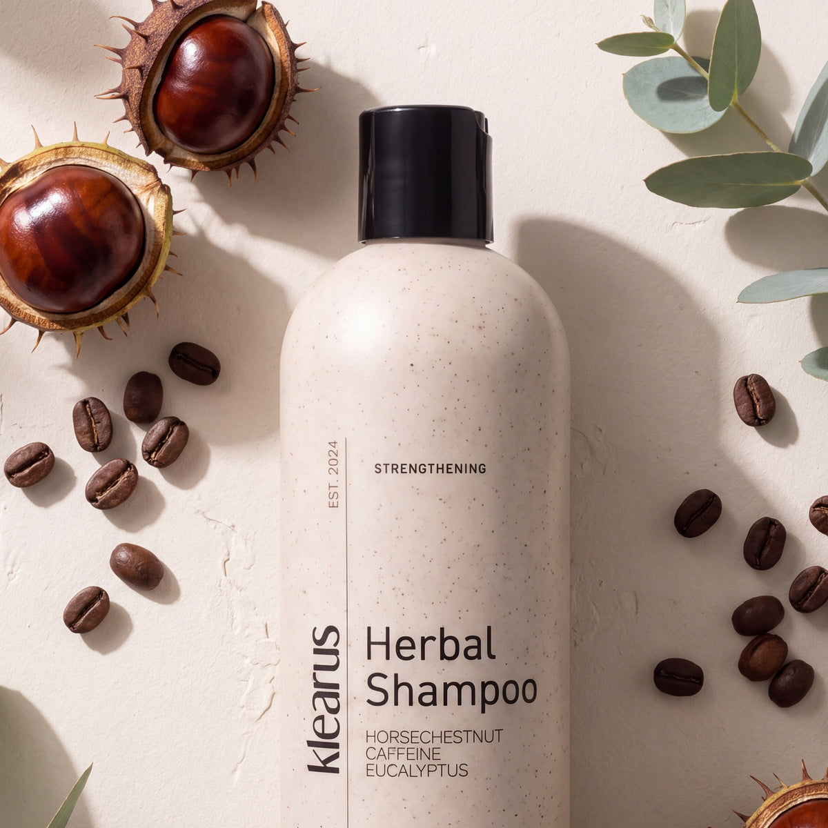 Klearus Strengthening herbal shampoo flat-lay with horse chestnuts, coffee beans and eucalyptus