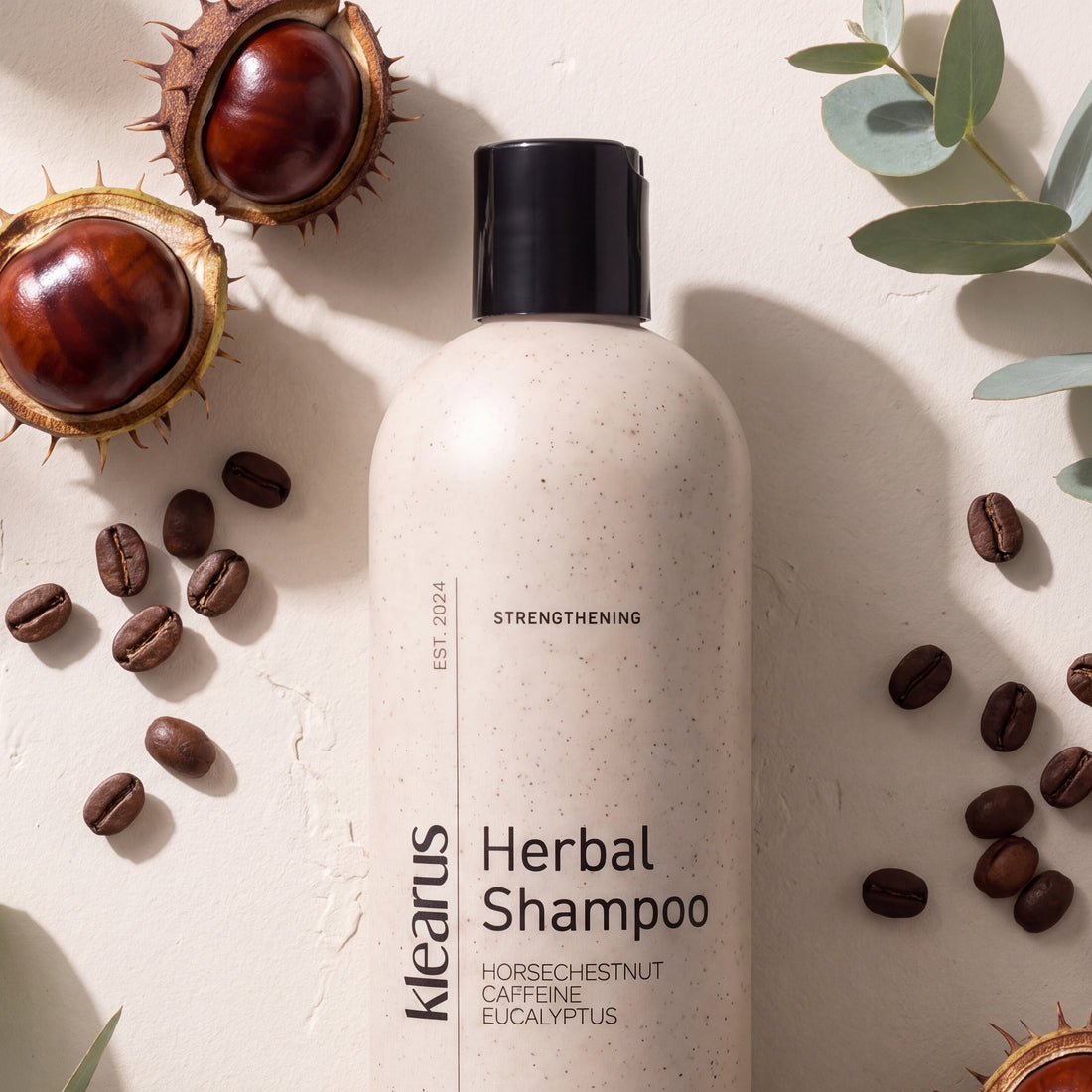 Klearus Strengthening herbal shampoo flat-lay with horse chestnuts, coffee beans and eucalyptus